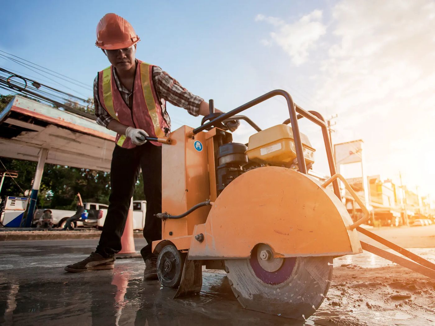 Walk-behind slab saw cutting a concrete surface